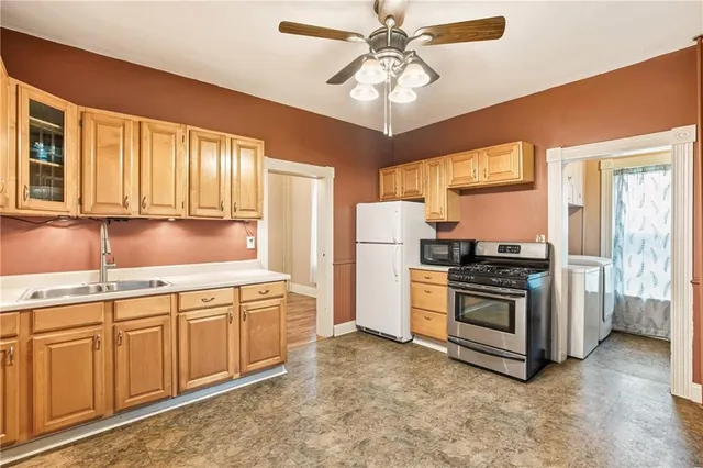 a kitchen with stainless steel appliances granite countertop a stove and a refrigerator