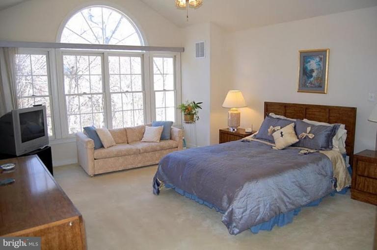 154 Rees Place Falls Church, VA 22046 - Photo 15 of 21 a spacious bedroom with a bed and a large window