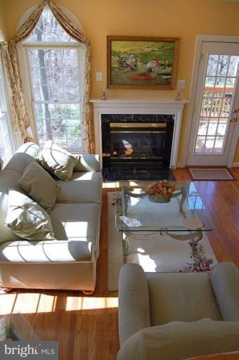 154 Rees Place Falls Church, VA 22046 - Photo 3 of 21 a living room with furniture a flat screen tv and a fireplace
