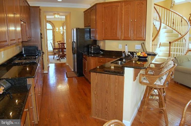 154 Rees Place Falls Church, VA 22046 - Photo 5 of 21 a kitchen with stainless steel appliances granite countertop a refrigerator a stove top oven a sink and dishwasher