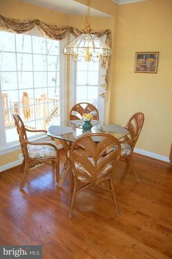 154 Rees Place Falls Church, VA 22046 - Photo 8 of 21 a view of a dining room with furniture wooden floor and a chandelier