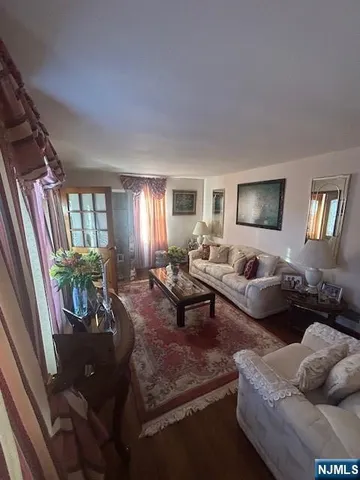 a living room with furniture lamp and window