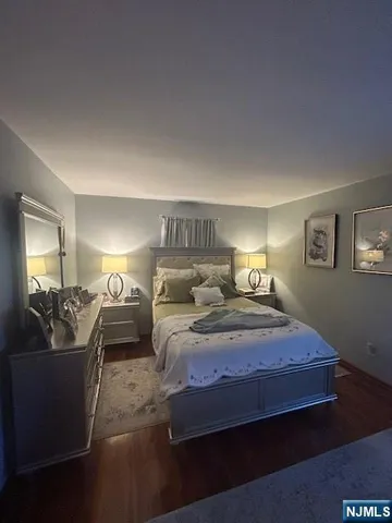 a bedroom with bed couch and window