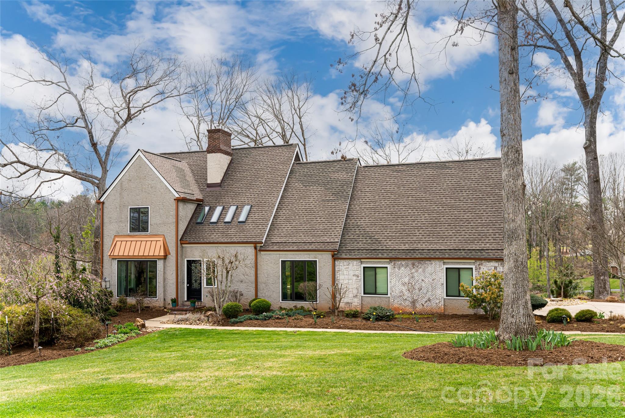210 Wildflower Road Asheville, NC 28804 - Photo 1 of 46 a front view of a building with garden