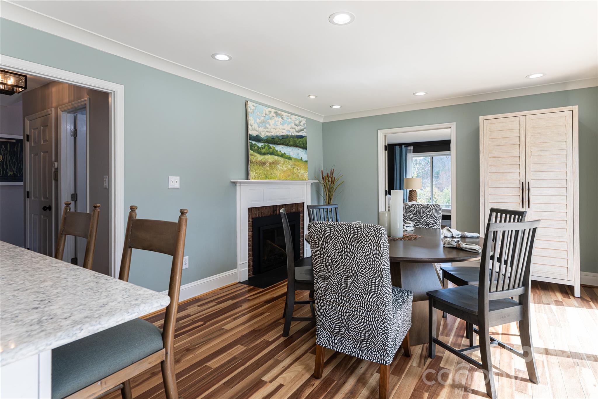210 Wildflower Road Asheville, NC 28804 - Photo 15 of 46 a dining room with furniture a fireplace and wooden floor