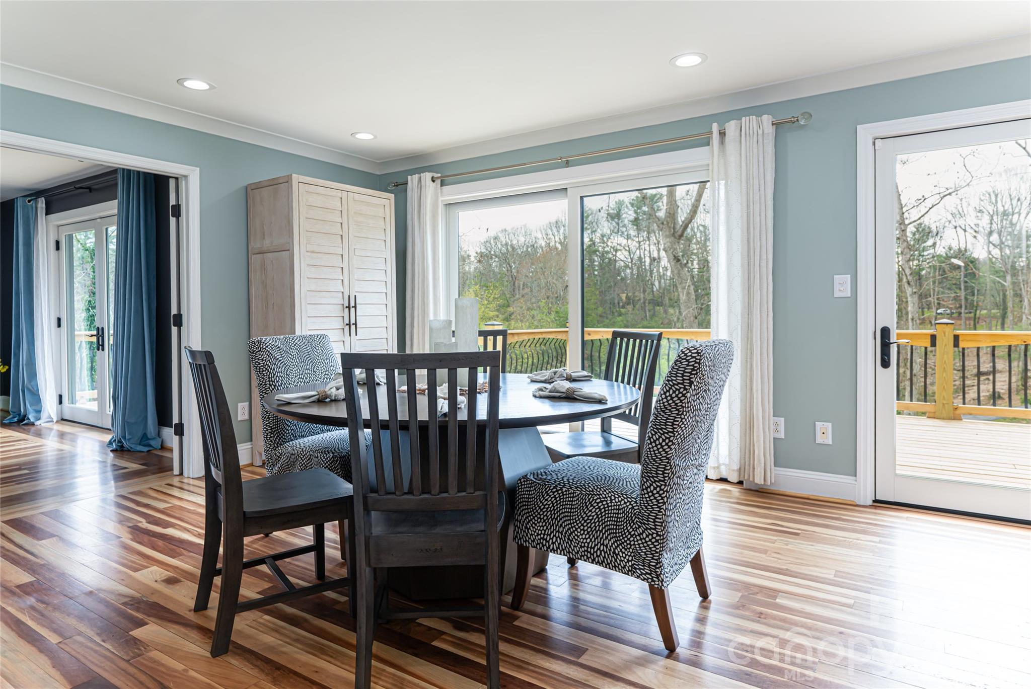 210 Wildflower Road Asheville, NC 28804 - Photo 18 of 46 a view of a dining room with furniture window and wooden floor