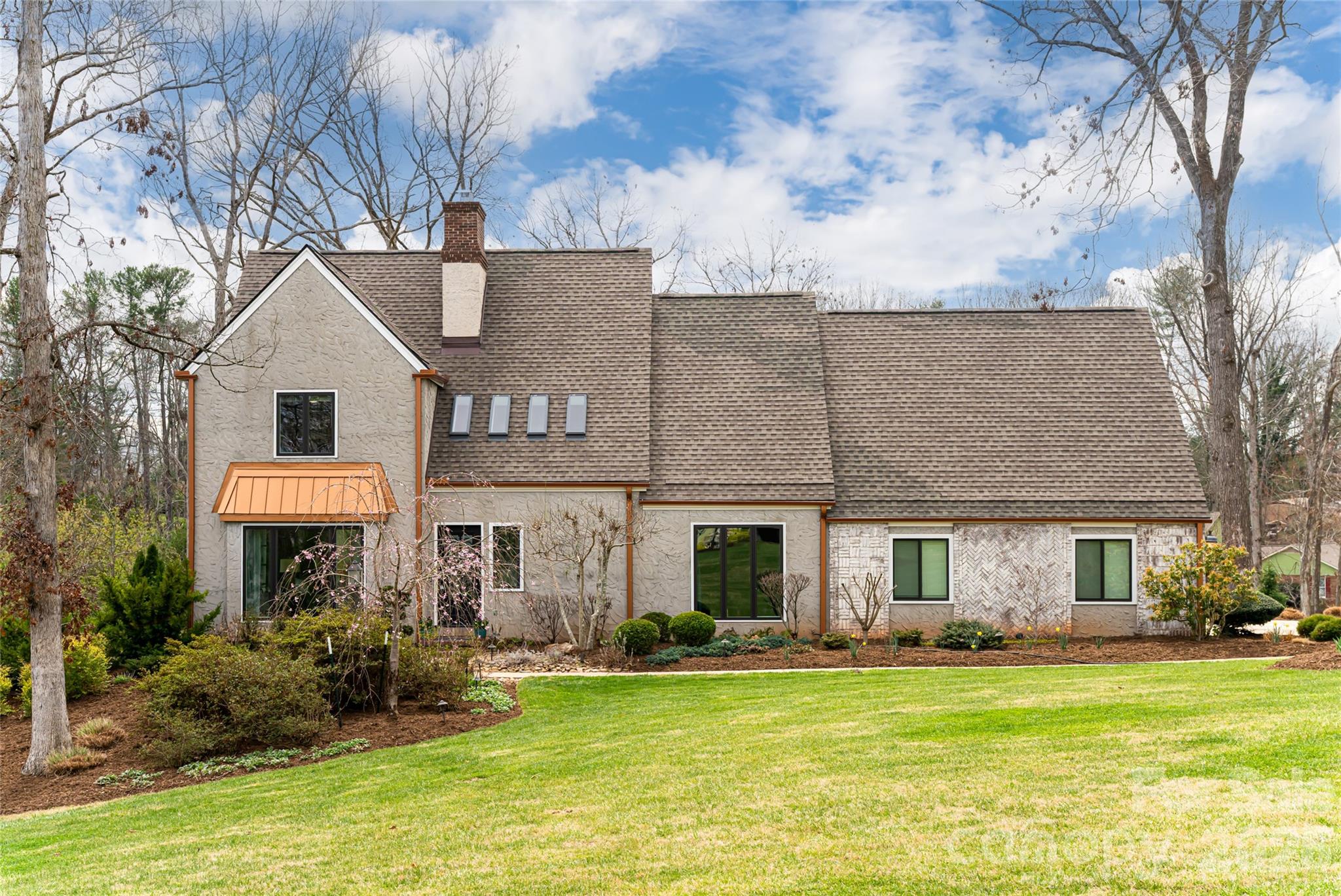 210 Wildflower Road Asheville, NC 28804 - Photo 2 of 46 a front view of house with yard and trees in the background