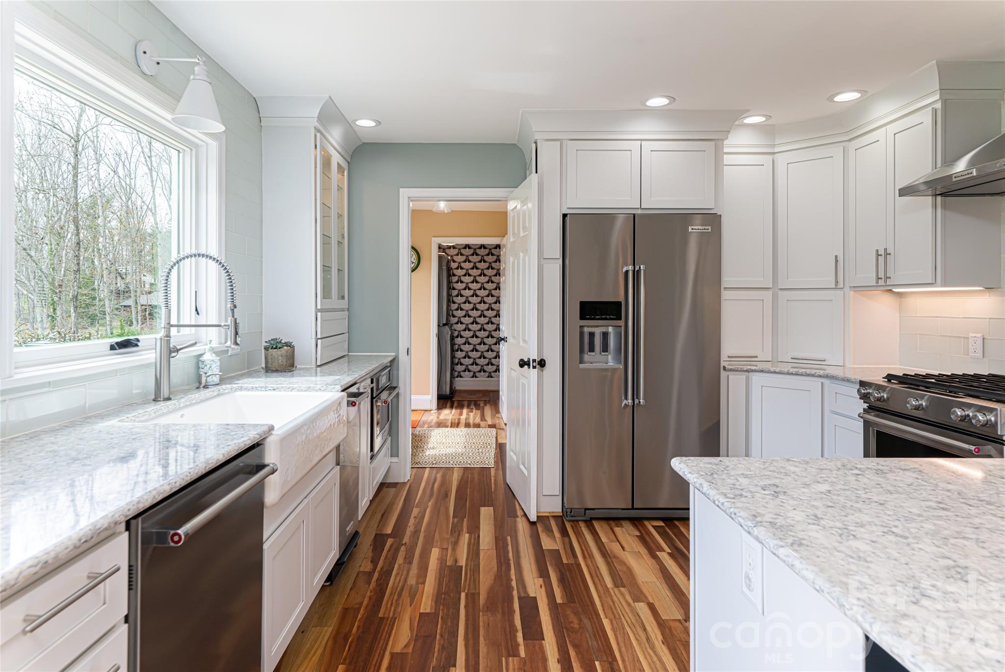 210 Wildflower Road Asheville, NC 28804 - Photo 22 of 46 a kitchen with kitchen island granite countertop a sink stove refrigerator and cabinets