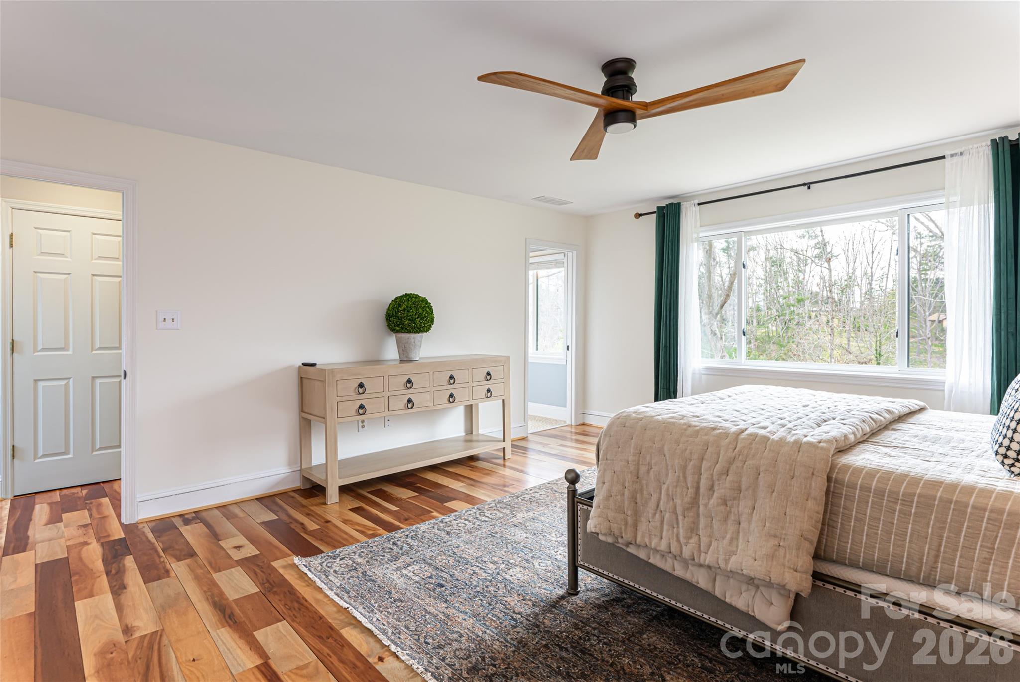 210 Wildflower Road Asheville, NC 28804 - Photo 26 of 46 a bedroom with a bed and wooden floor