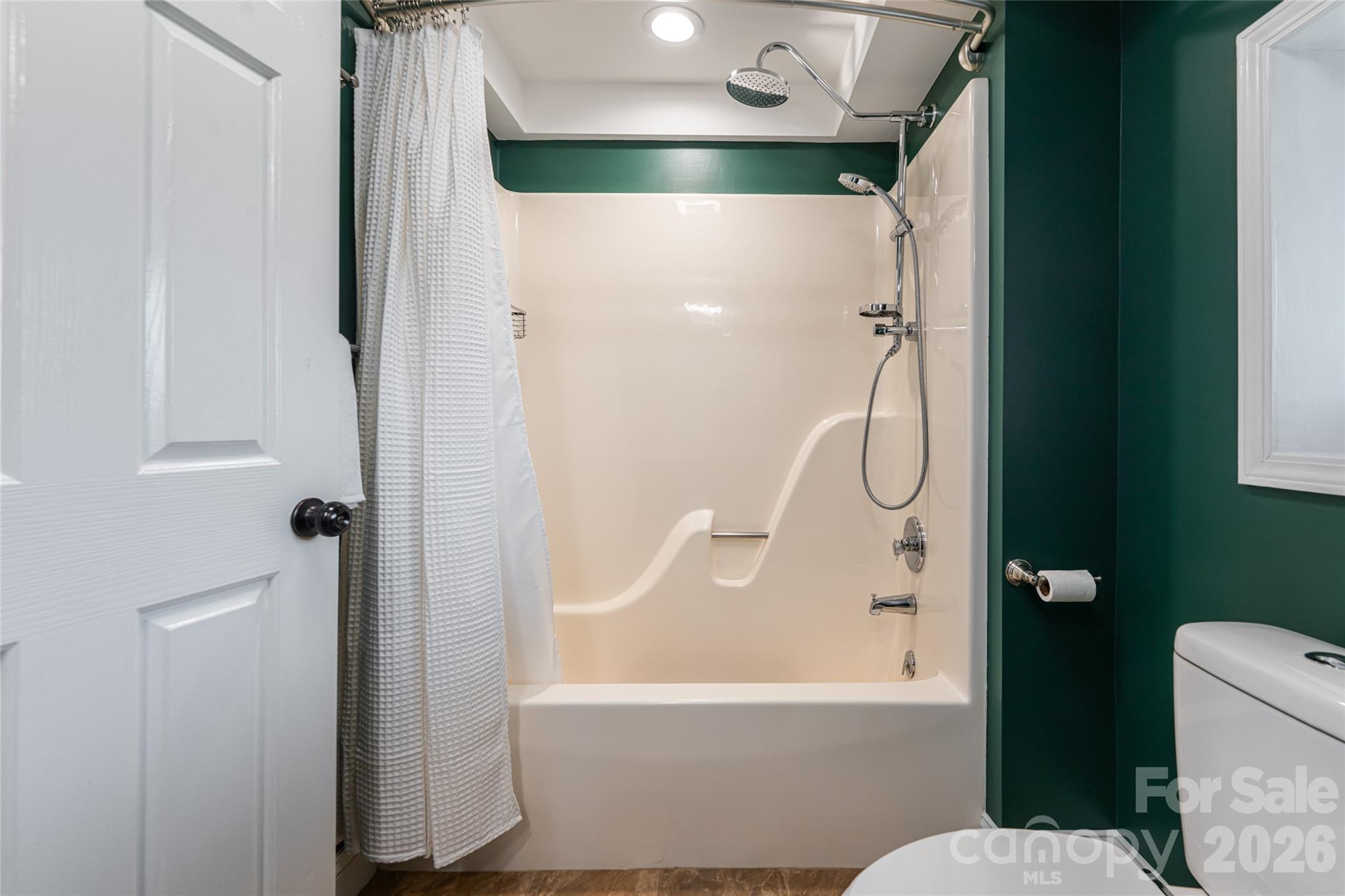 210 Wildflower Road Asheville, NC 28804 - Photo 35 of 46 a bathroom with a bathtub and a shower