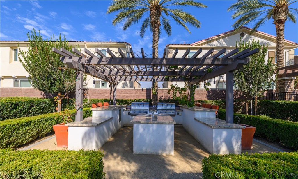 8825 Celebration Street Chino, CA 91708 - Photo 18 of 30 a view of a patio with table and chairs potted plants