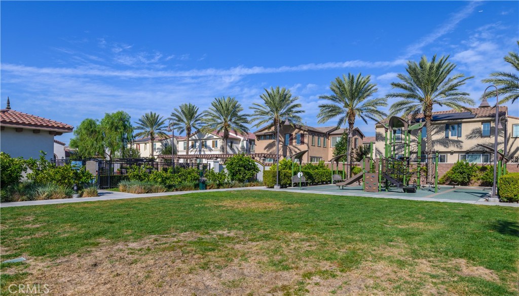 8825 Celebration Street Chino, CA 91708 - Photo 25 of 30 a front view of multi story residential apartment building with yard