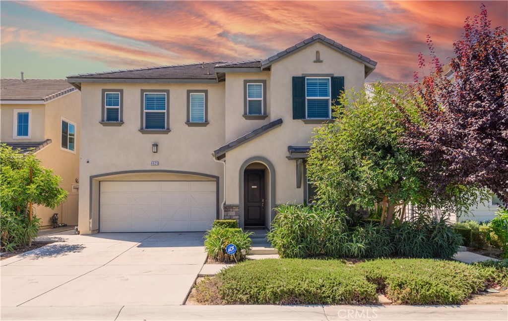 8825 Celebration Street Chino, CA 91708 - Photo 3 of 30 a front view of a house with garden