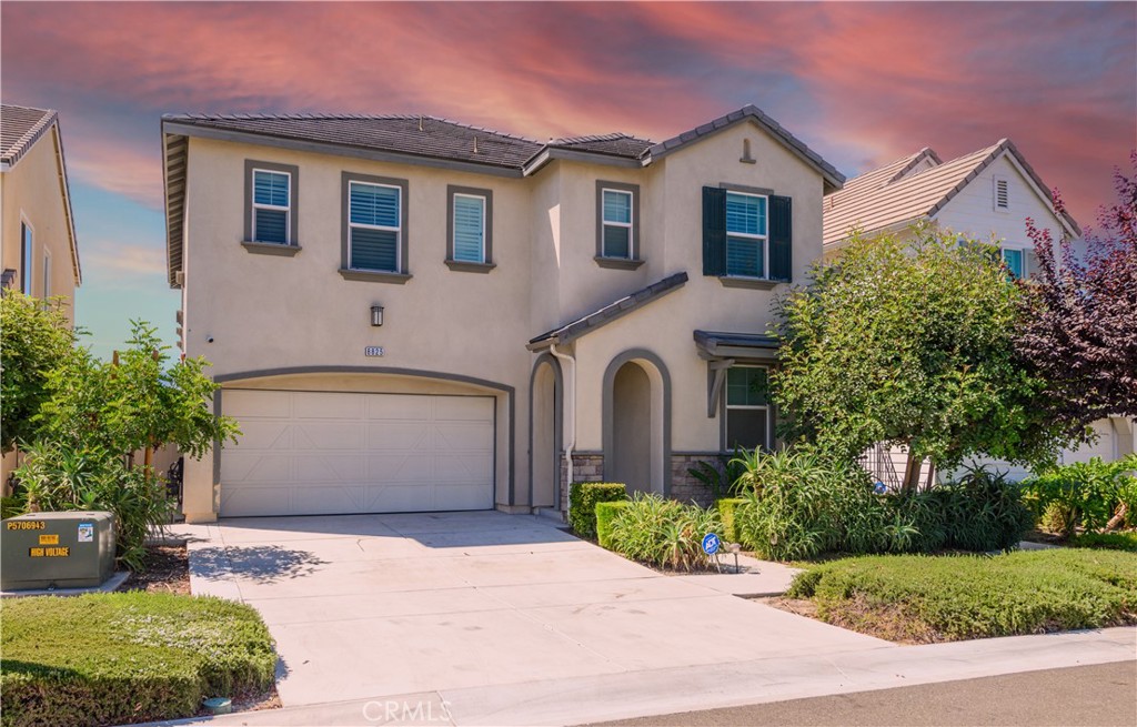 8825 Celebration Street Chino, CA 91708 - Photo 4 of 30 a front view of a house with garden