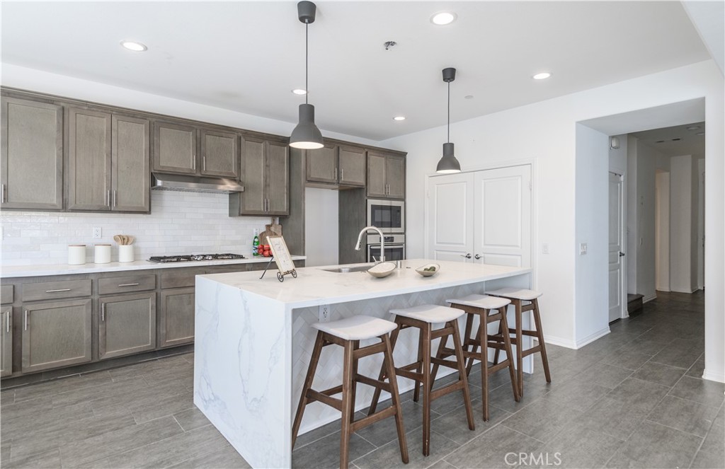 8825 Celebration Street Chino, CA 91708 - Photo 5 of 30 a kitchen with a sink and chairs