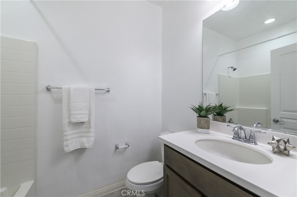 8825 Celebration Street Chino, CA 91708 - Photo 9 of 30 a bathroom with a granite countertop sink toilet and shower