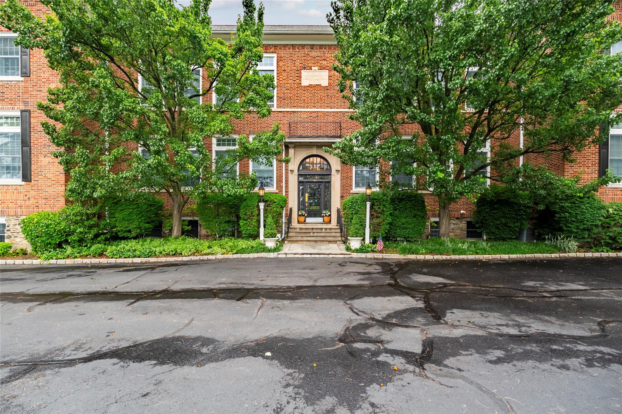 20 Whippoorwill Road East, Unit 2A Armonk, NY 10504 - Photo 1 of 1 a front view of a house with a yard and a garage