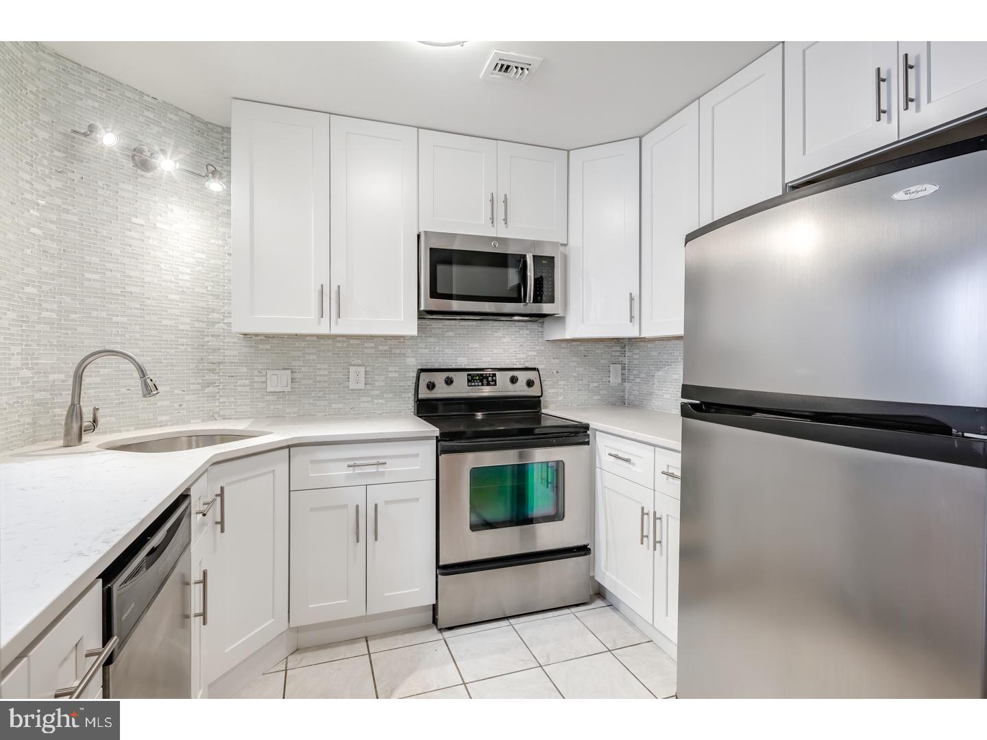 12-16 Letitia Street, Unit 503 Philadelphia, PA 19106 - Photo 1 of 12 a kitchen with a sink a stove and cabinets