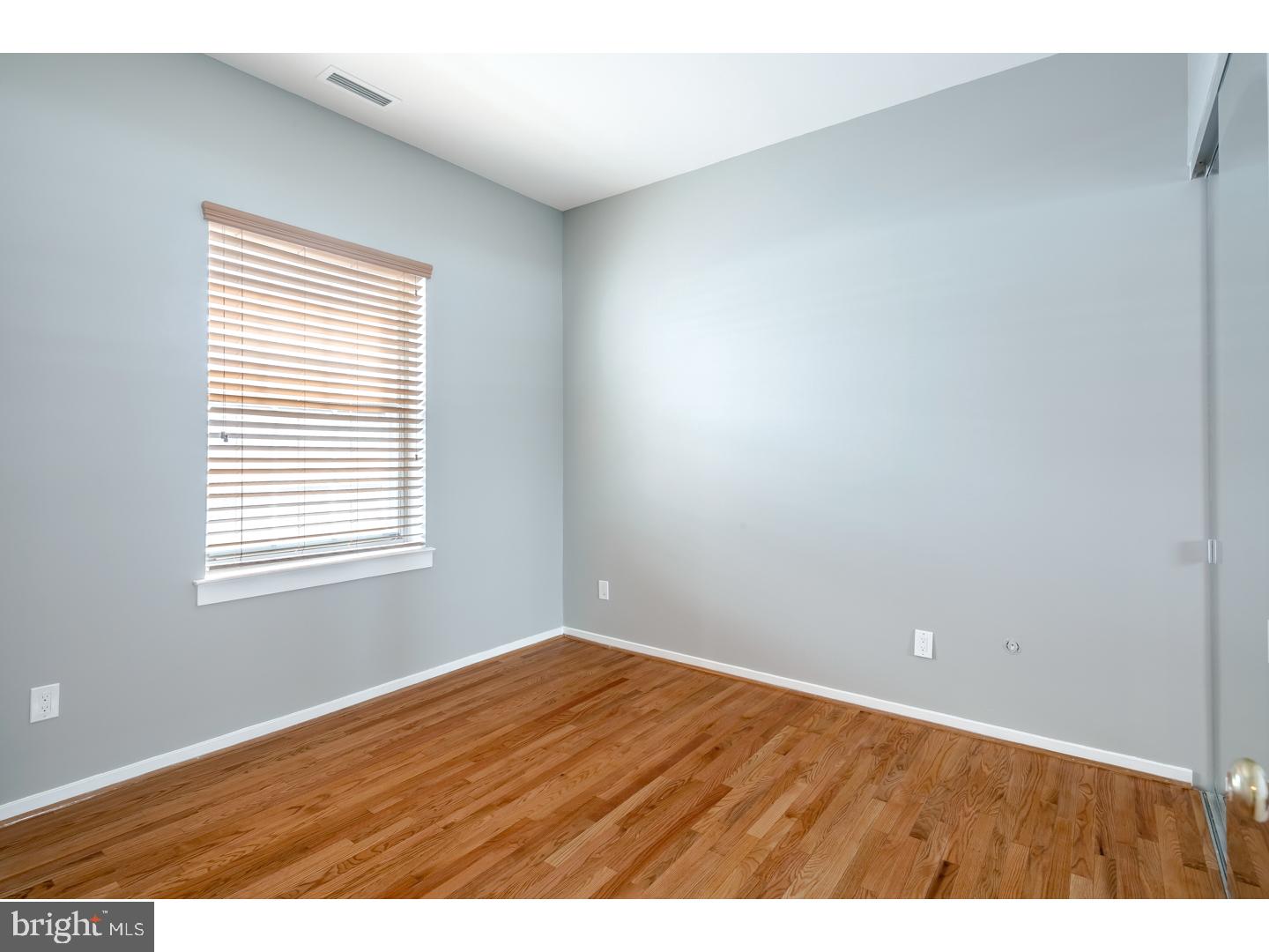 12-16 Letitia Street, Unit 503 Philadelphia, PA 19106 - Photo 12 of 12 a view of an empty room with wooden floor and a window