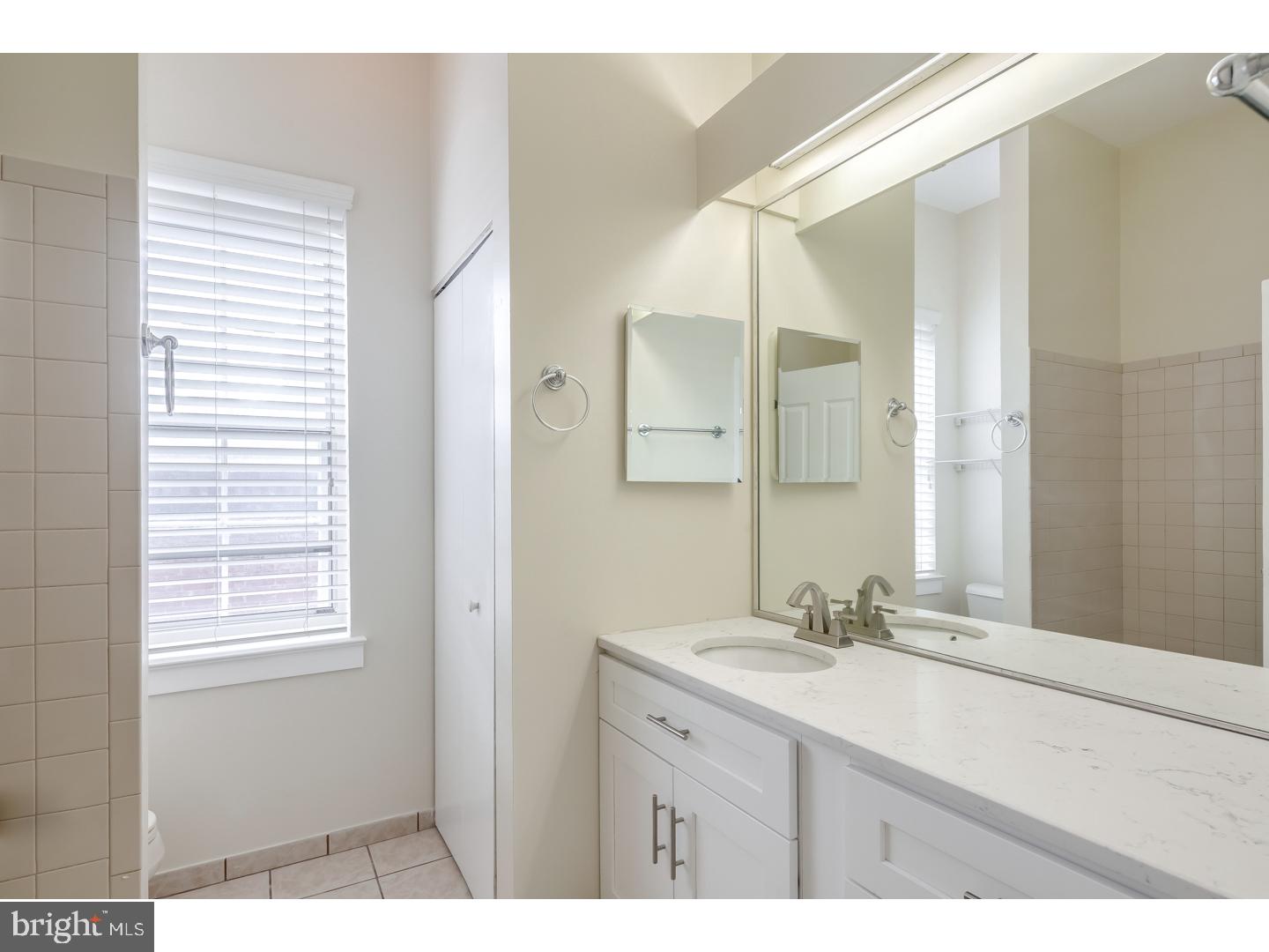 12-16 Letitia Street, Unit 503 Philadelphia, PA 19106 - Photo 9 of 12 a bathroom with a sink double vanity and a mirror