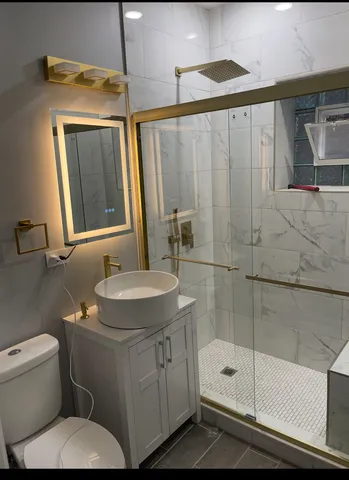 a bathroom with a sink toilet and shower