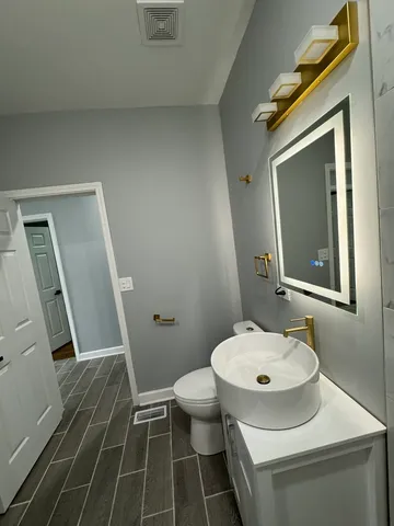 a bathroom with a sink toilet and shower