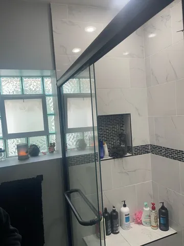 a bathroom with a toilet and a mirror