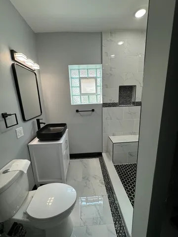 a view of a hallway with workspace and mirror