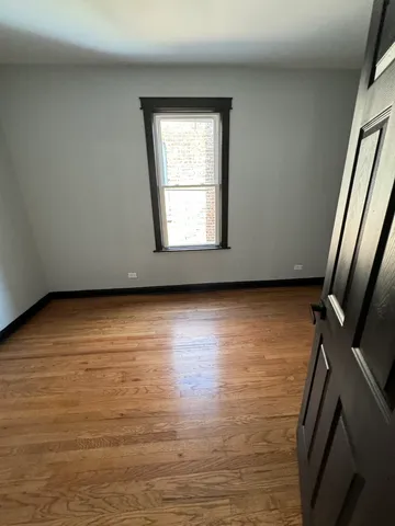 a view of an empty room with glass door