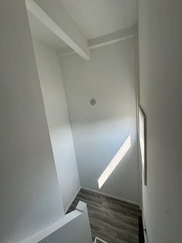 a view of a empty room with wooden ceiling