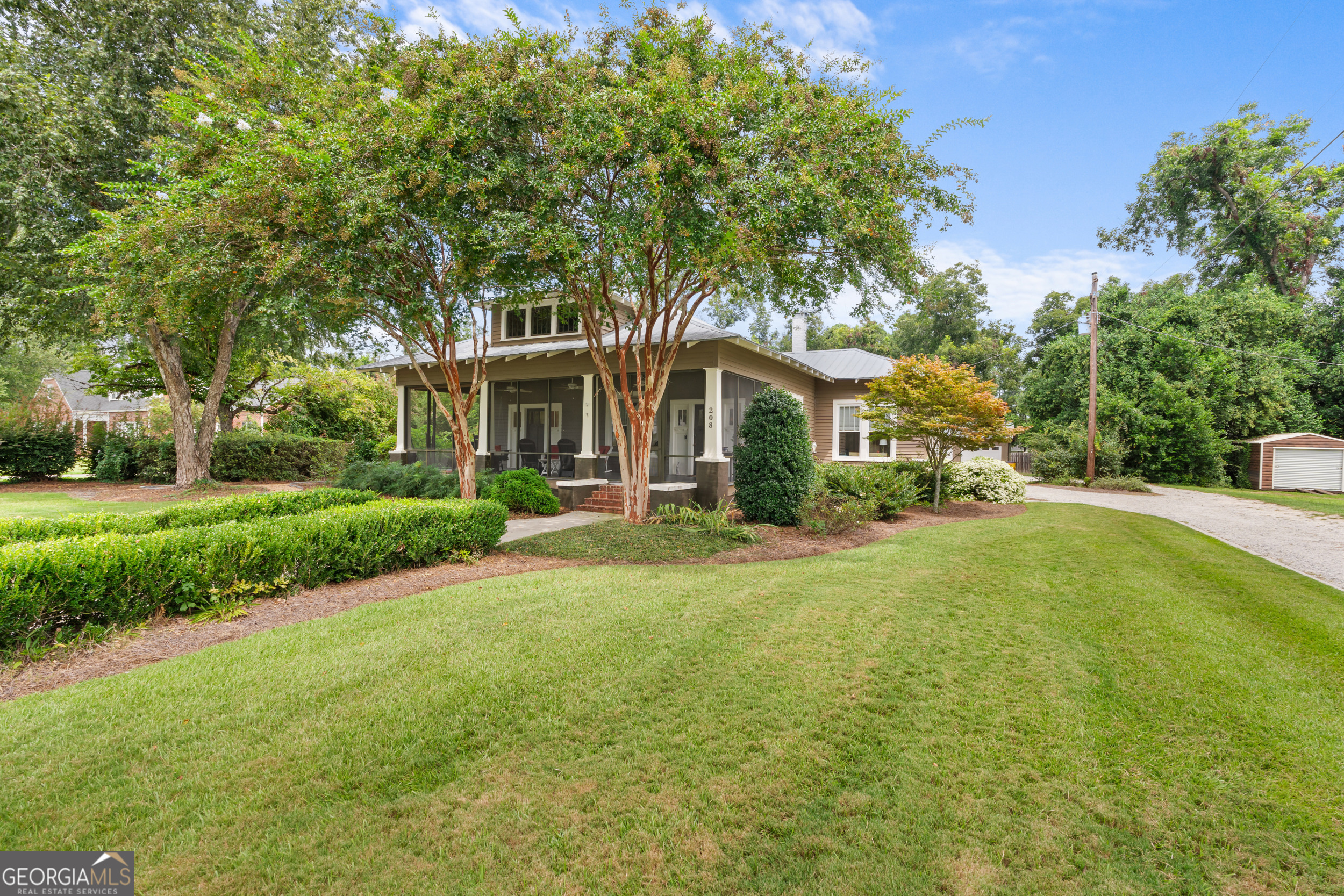 a front view of a house with yard and green space