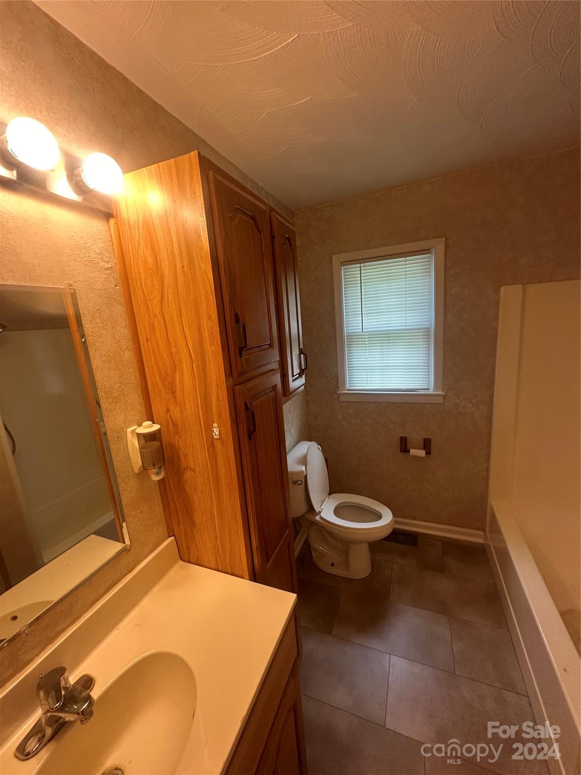 1854 Holland Drive Conover, NC 28613 - Photo 10 of 14 a bathroom with a granite countertop sink toilet and shower