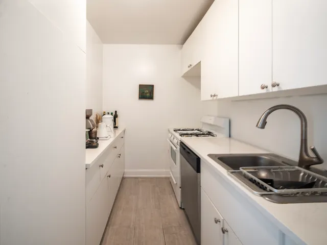 a kitchen with sink a stove and refrigerator