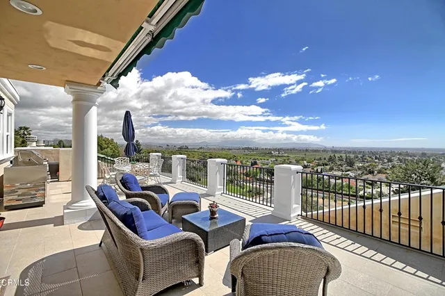 a view of balcony with furniture