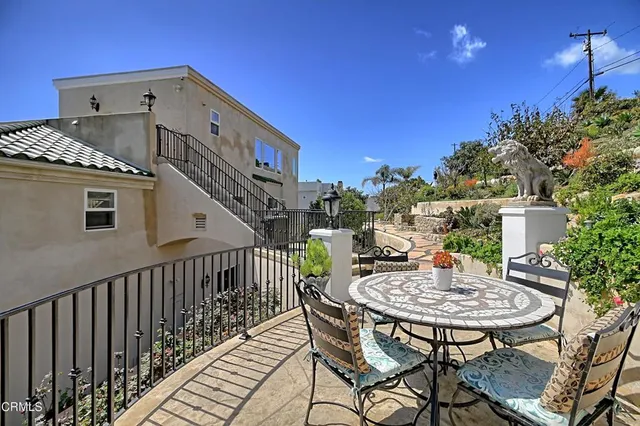 a balcony with a table and chairs