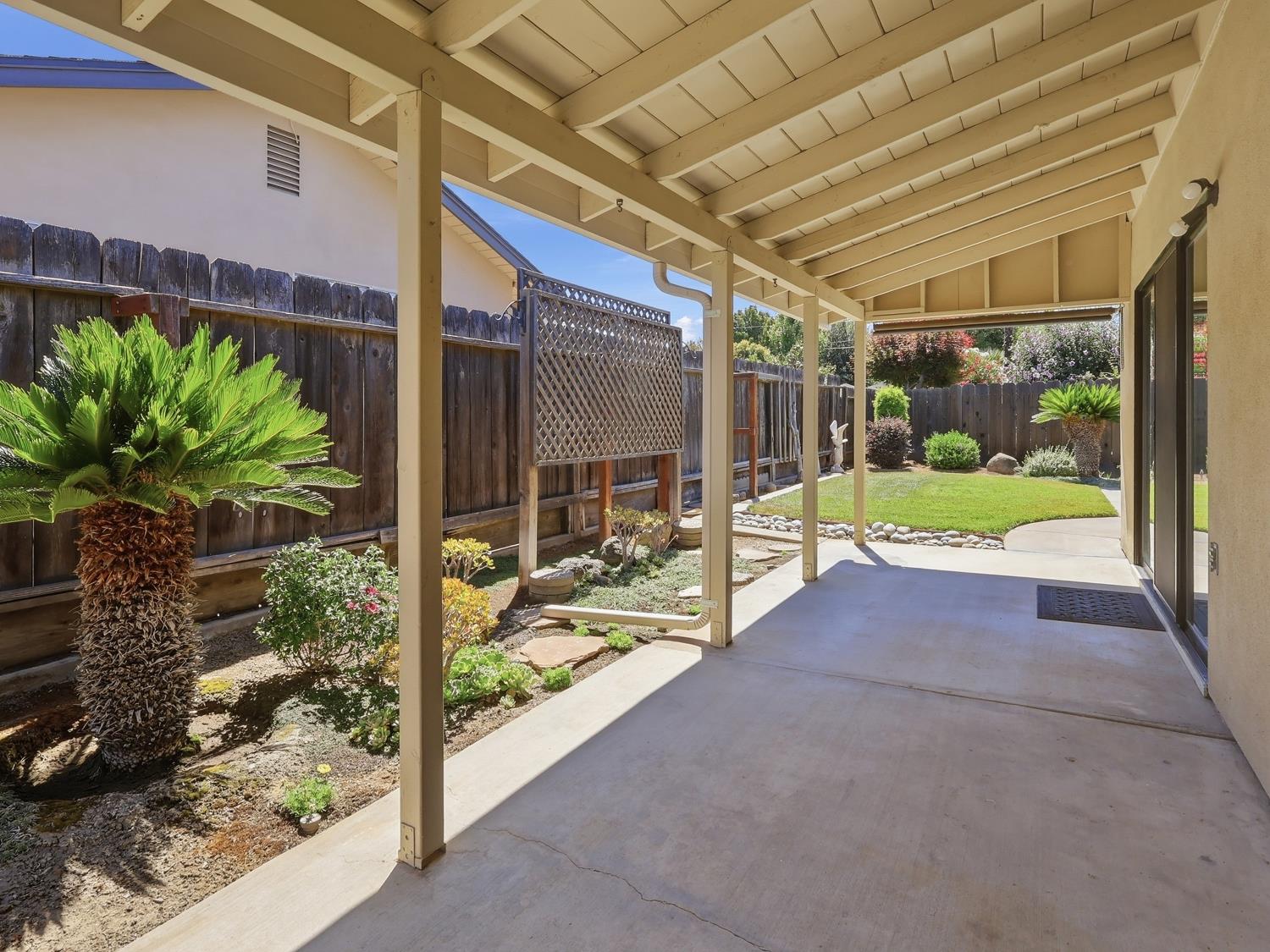 900 Multnomah Drive Modesto, CA 95350 - Photo 23 of 34 Covered patio featuring concrete flooring and a wood-slat ceiling.