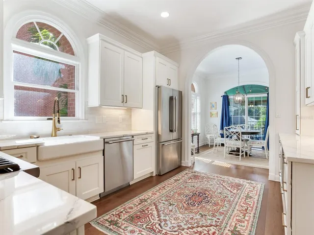 a living room with furniture a fireplace and a large window