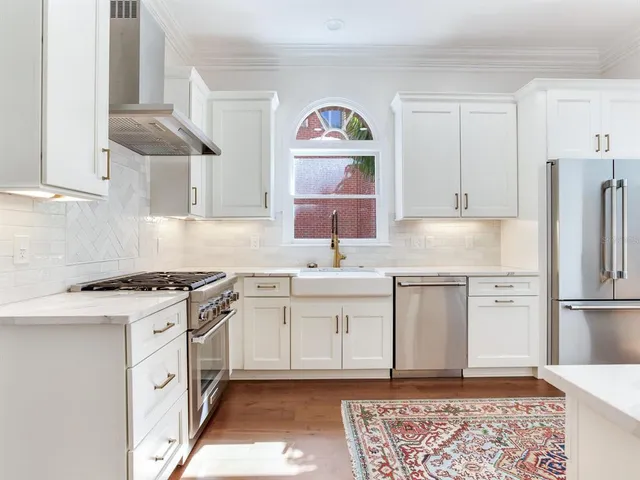 a view of a patio with table and chairs and potted plants