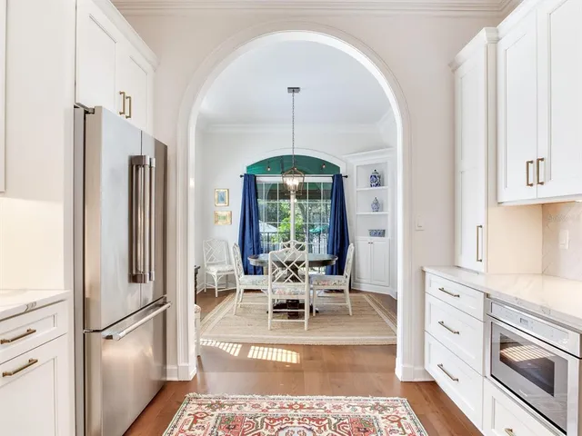 a view of a bedroom with wooden floor and a bathroom