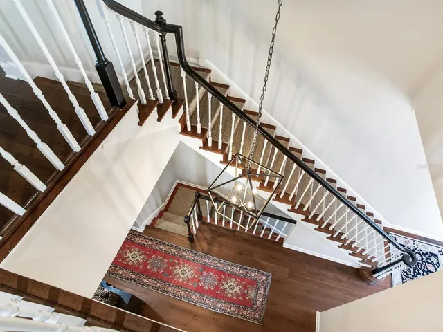 a view of a patio with table and chairs potted plants and palm tree