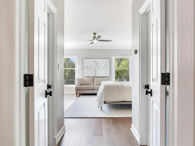 a view of a patio with table and chairs potted plants and a large tree