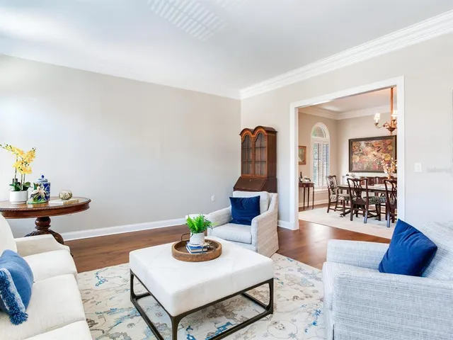 a view of a hallway with wooden floor and furniture