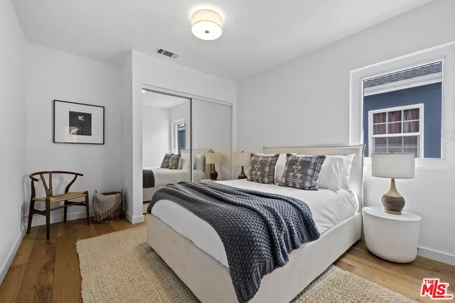 a spacious bedroom with a bed and window