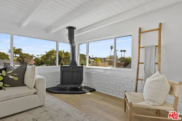 a view of living room with furniture and a floor to ceiling window