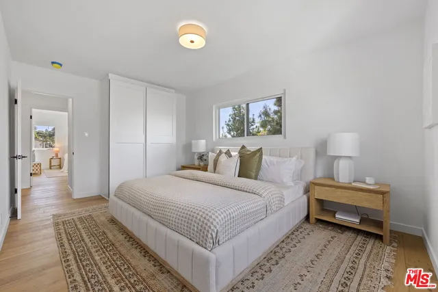 a bedroom with a bed and a night stand