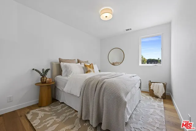 a bedroom with a bed and a lamp