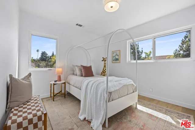 a bedroom with a bed and glass window