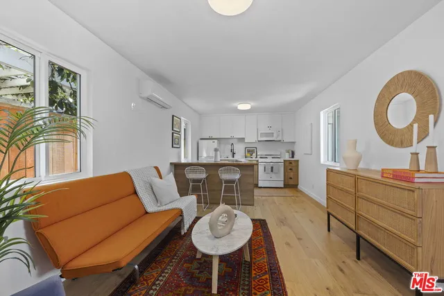 a living room with furniture a couch and kitchen view