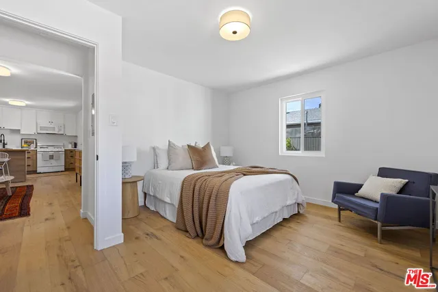 a bedroom with a bed and a chair