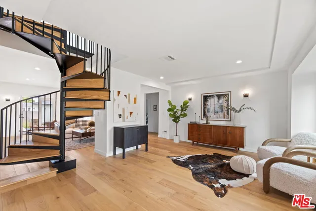 a bedroom with furniture and a wooden floor